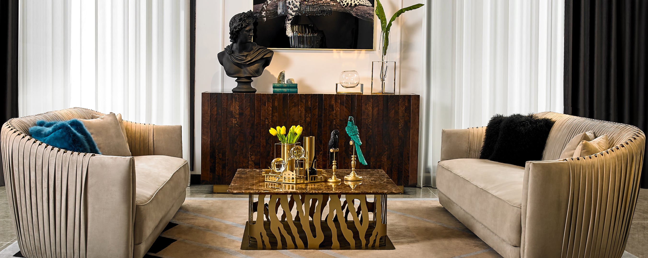 Styled living room with sofas, coffee table, and decorative accents